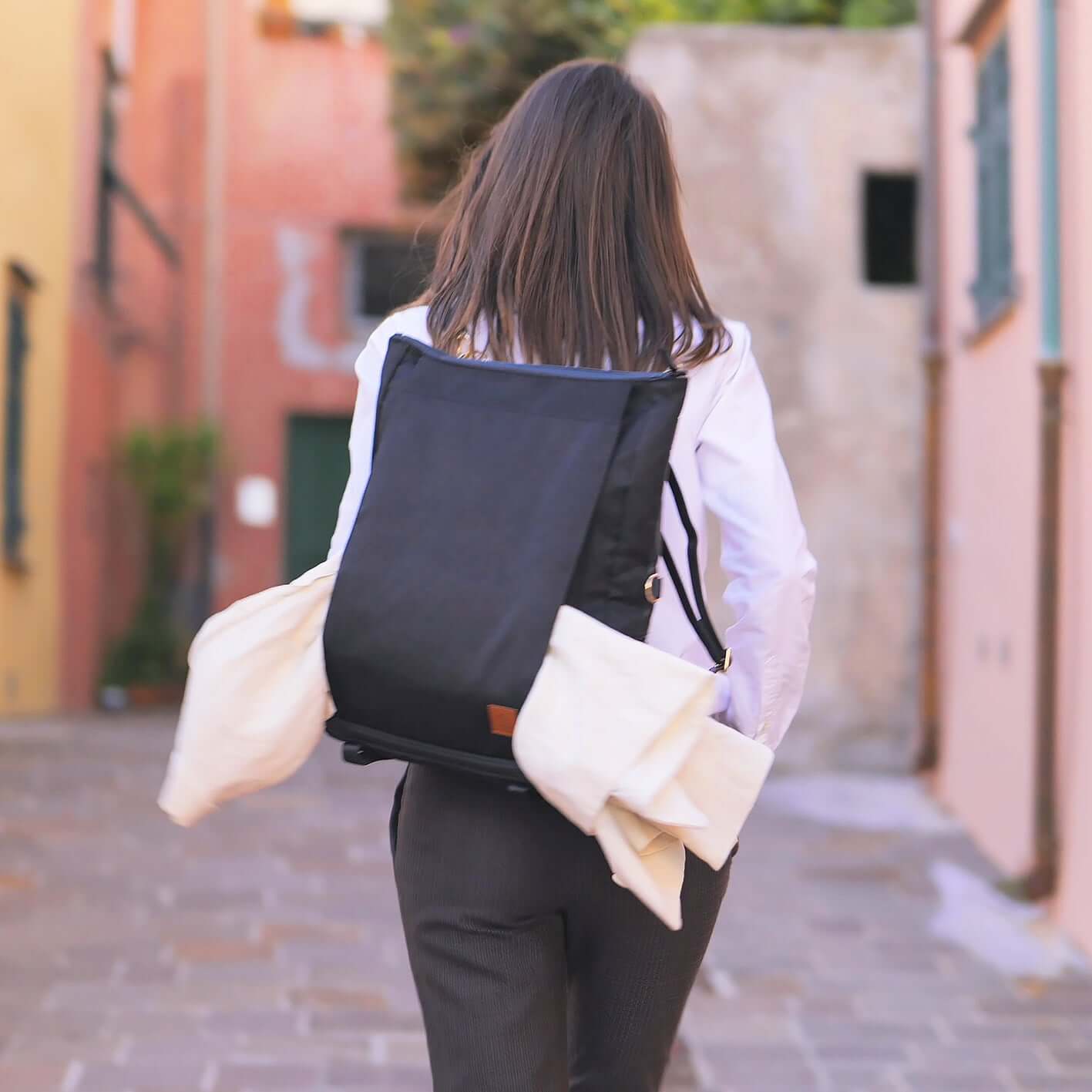 woman wearing backpack with jacket holder